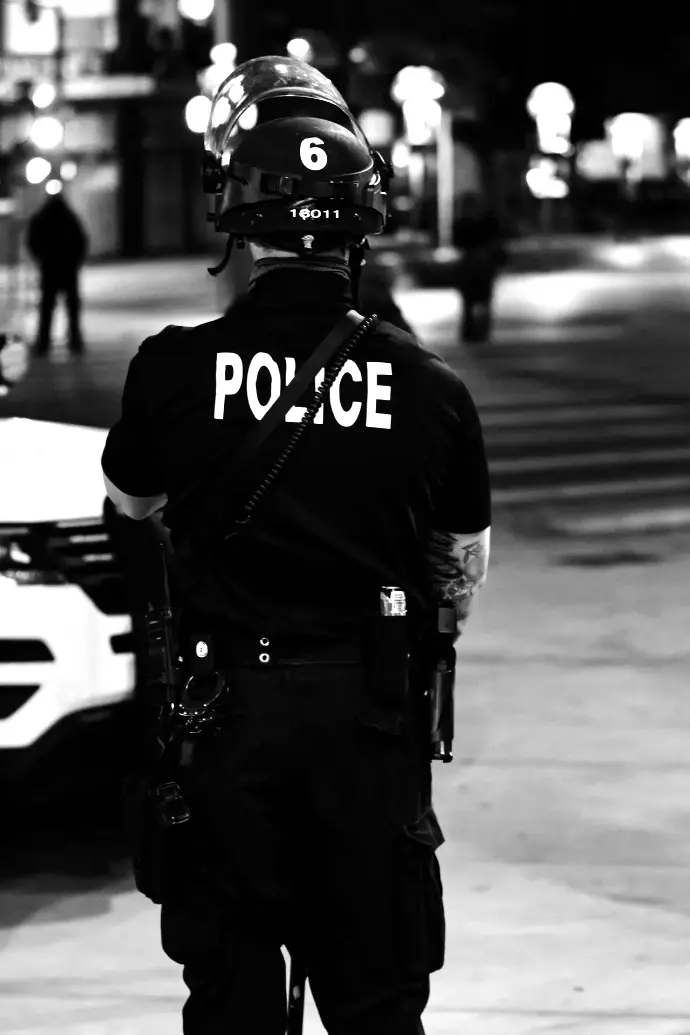 man in black and white adidas jacket and black helmet standing on road during daytime